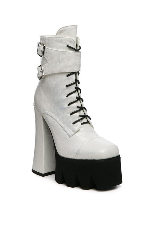 Stomper High Platform Boots designed with a block heel and platform for added height. Made with durable polyurethane and a rubber sole, these boots feature a lace-up design, buckle detail, and side zipper for both style and functionality. Stay on trend with these solid color boots featuring a round toe and over-ankle length. Enjoy free shipping on ALL orders. Shop now!