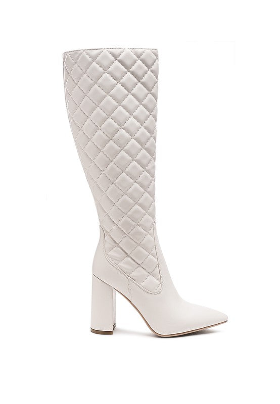 Quilt Knee High Boots expertly crafted with a quilted texture and block heels. Made with high-quality faux leather, polyurethane lining, and a durable TPR outer sole. Featuring a closed pointed toe and side zipper opening, these knee-high boots offer both style and functionality. Elevate your wardrobe with these fashionable and comfortable boots. Heel Height: 9.8 inches. Enjoy free shipping on ALL orders. Shop now!