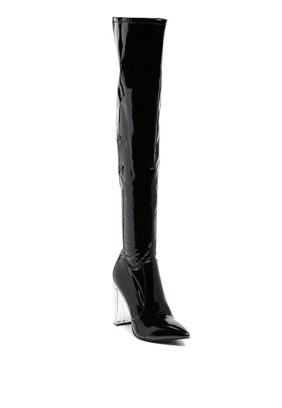 Stay stylish and warm this winter with our sleek Patent Clear Heel Boots. Made with stretchy patent PU material, they feature a polyurethane lining for added comfort. With a pointed toe and clear block heel, these thigh-high boots also have a side zipper opening for easy wear. Crafted from leather, they are a perfect winter essential. Enjoy free shipping on all orders. Shop now!