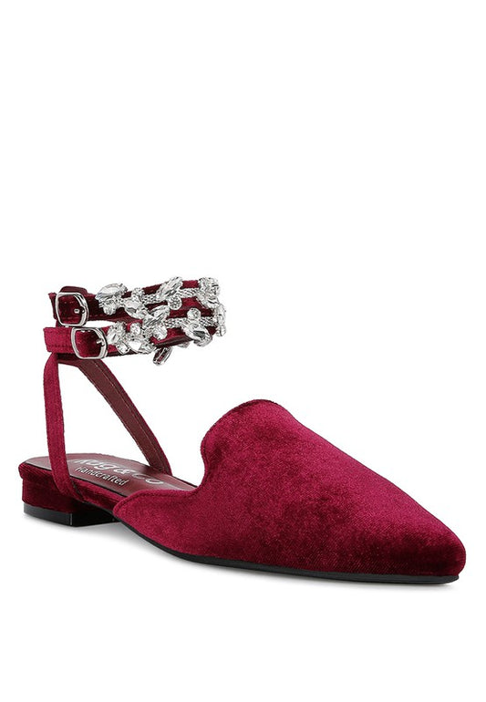 Velvet Jeweled Flat Mules featuring a soft leatherette lining and lightly padded insole for luxurious comfort. The closed pointed toe and high pointed heel provide a sleek, elegant look. Diamante jewel detail and double pin buckle fastening add a touch of glamour. Ideal for any occasion and a must-have for a fashion-forward wardrobe. Free shipping on all orders. Shop now!