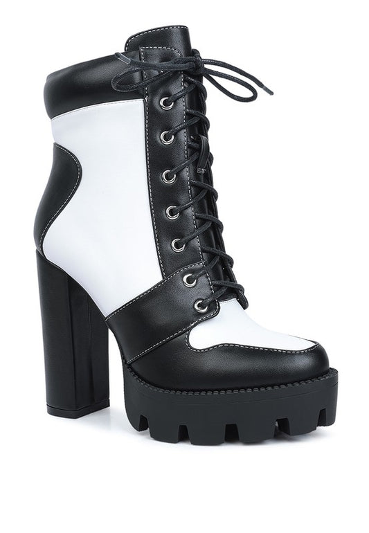 Two Tone Block Heel Boots with a trendy, edgy look. Crafted from high-quality PU material with a synthetic lining for durability and comfort. Features include a closed round toe, lace-up details, and a lug sole for stability. Lightweight platform block heel adds height and style. Enjoy free shipping on ALL orders. Shop now!