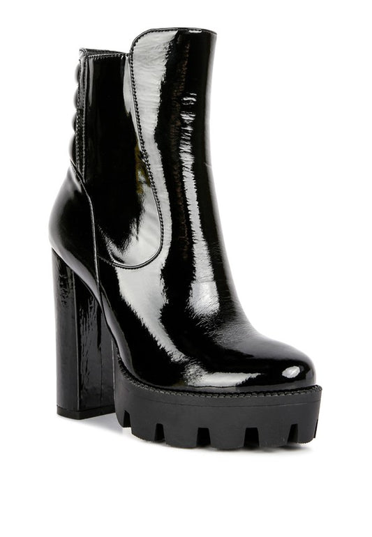 Shiny Patent Ankle Boots crafted from faux leather with a synthetic lining. Features a TPR outer sole, closed toe, side zipper detail, quilted collar design, lug sole, and high block heel. Free shipping on all orders. Shop now!