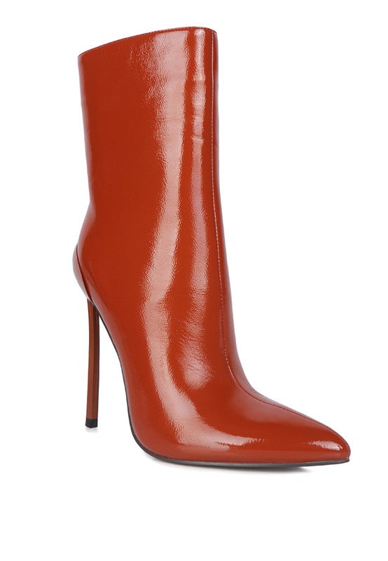 Patent Stiletto Heeled Boot featuring a closed pointed toe, solid heel cap, patent PU outer material, synthetic lining, and durable TPR outer sole. Elasticated gussets and side zipper opening for a secure and comfortable fit. Sleek, stylish ankle boot design. Free shipping on all orders. Shop now!