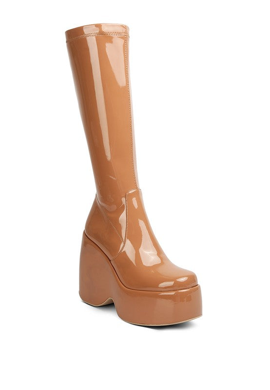 Patent Platform Calf Boots for women, made with high-quality Patent PU outer material and a synthetic lining for added comfort. Featuring a closed square toe, side zipper detail, high block heel, and platform for a comfortable walking experience. The lightly padded insole provides extra cushioning. Perfect for upgrading your fall fashion game with chic, versatile style. Enjoy free shipping on ALL orders. Shop now!