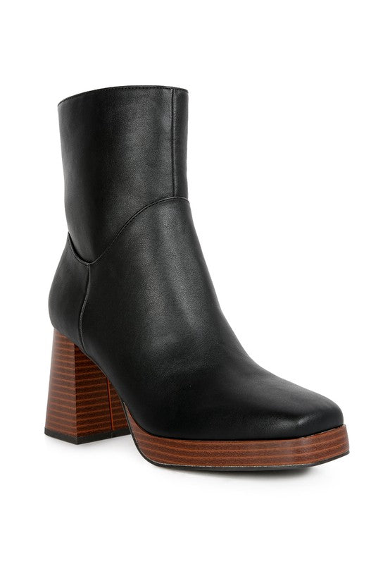 Ankle Platform Block Boots crafted from patent PU outer material with a synthetic lining for a sleek look. Featuring a TPR outer sole for traction, a square closed toe, high heel for sophistication, and a lightly cushioned insole for comfort. Easy to slip on with a side zipper opening. Enjoy free shipping on all orders. Shop now!