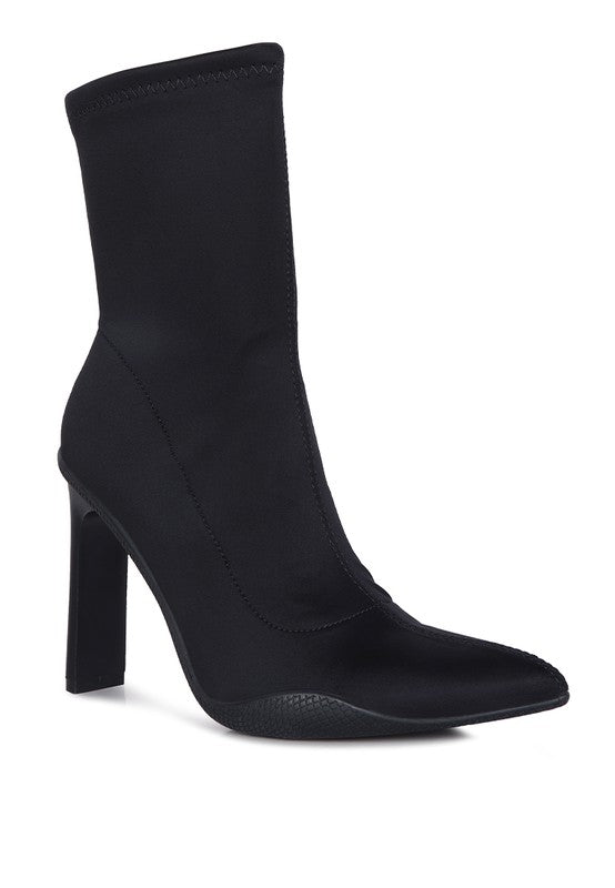 Black Stretch Ankle Boots crafted with high-quality PU material and a synthetic lining. Features a pointed toe, platform block heel, and TPR outer sole for support. Lightly cushioned insole and side zipper opening for added comfort and convenience. Elevate your look with these stylish boots. Free shipping on all orders. Shop now!