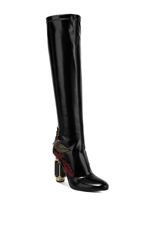 Rhinestone Knee High Boots crafted from patent faux leather with a closed almond toe and rhinestone-embellished patchwork design. The jewel fantasy heel adds glamour, while lightly cushioned insoles provide comfort. Zipper closure ensures a secure fit. Elevate any outfit with these stunning calf-length boots. Enjoy free shipping on all orders. Shop now!