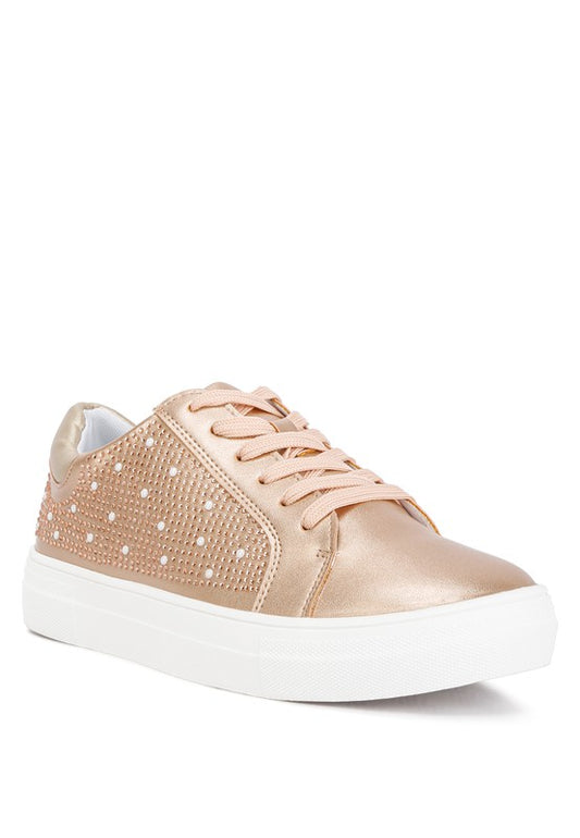 Metallic embellished sneakers featuring a sleek metallic faux leather upper, light cushion insoles, and a durable TPR outer sole. Designed with a lace-up fastening, rhinestone and pearl embellishments, a flatform heel, and a metallic back panel. Perfect for combining style and comfort. Free shipping on all orders. Shop now!