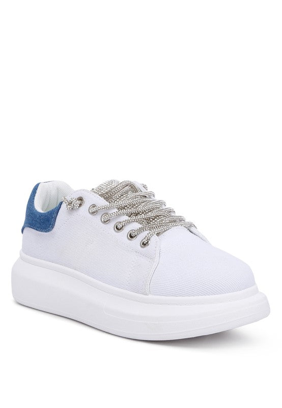 Trendy Rhinestones Lace-Up Sneakers featuring a durable faux leather upper and closed round toe. Designed with a chunky flatform sole for comfortable height, these sneakers showcase rhinestone embellished laces and tongue, adding a touch of sparkle. Perfect for elevating any outfit. Free shipping on all orders. Shop now!
