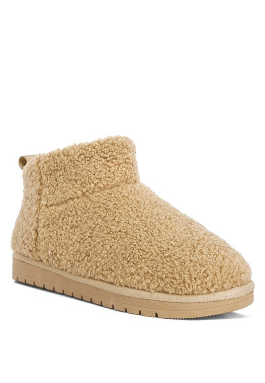 Fleece Exterior Fluffy Booties designed for maximum comfort and warmth on colder days. Featuring a soft fleece exterior for insulation, a durable rubber sole, and a closed rounded toe. The slip-on style with pull tabs ensures easy wear and removal, while lightly cushioned insoles provide additional support for all-day comfort. Enjoy free shipping on all orders. Shop now!